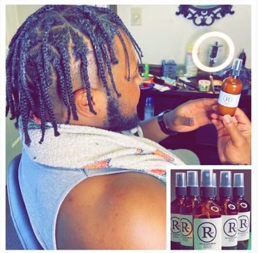 Man with braided hair holding a bottle of hair growth spray.