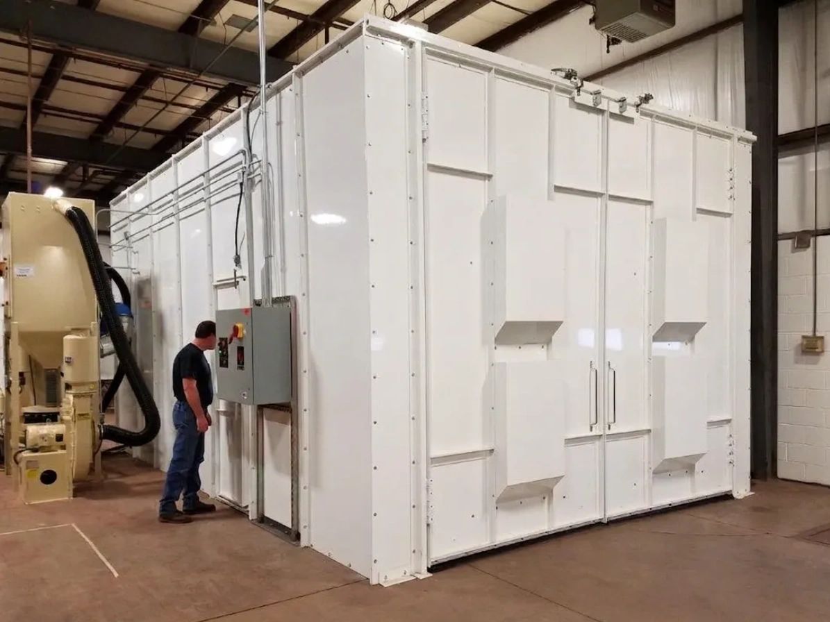 A man inspecting a large industrial white machine in a warehouse.
