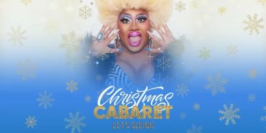 A festive drag performer with bold makeup for Christmas Cabaret.