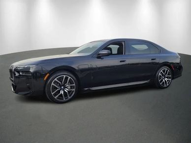 Sleek black luxury sedan parked in a well-lit studio.
