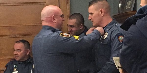 Officer Jonathan Imperial being awarded a life-saving medal.