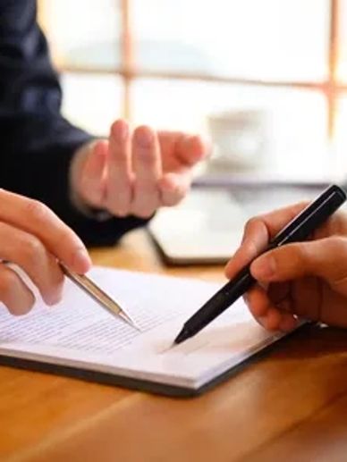 two people going through a document