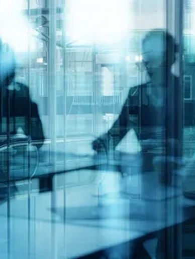 a photo of a business meeting through glass