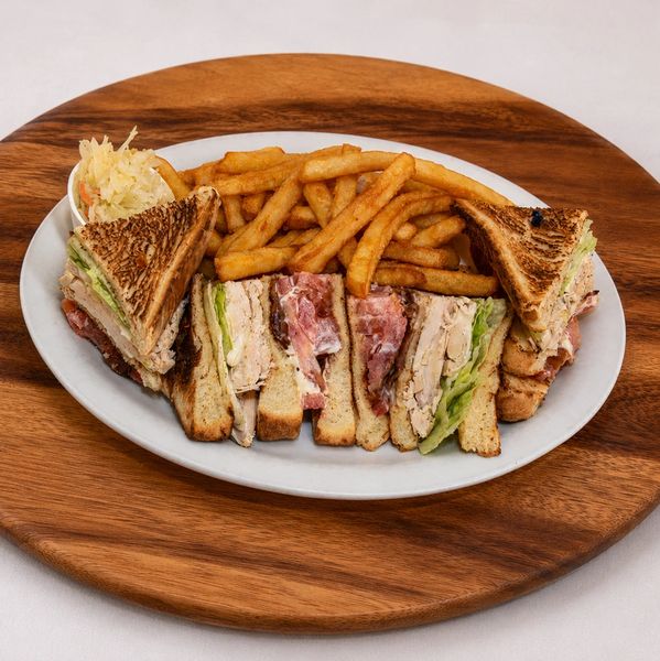 Club sandwich with fries and coleslaw.