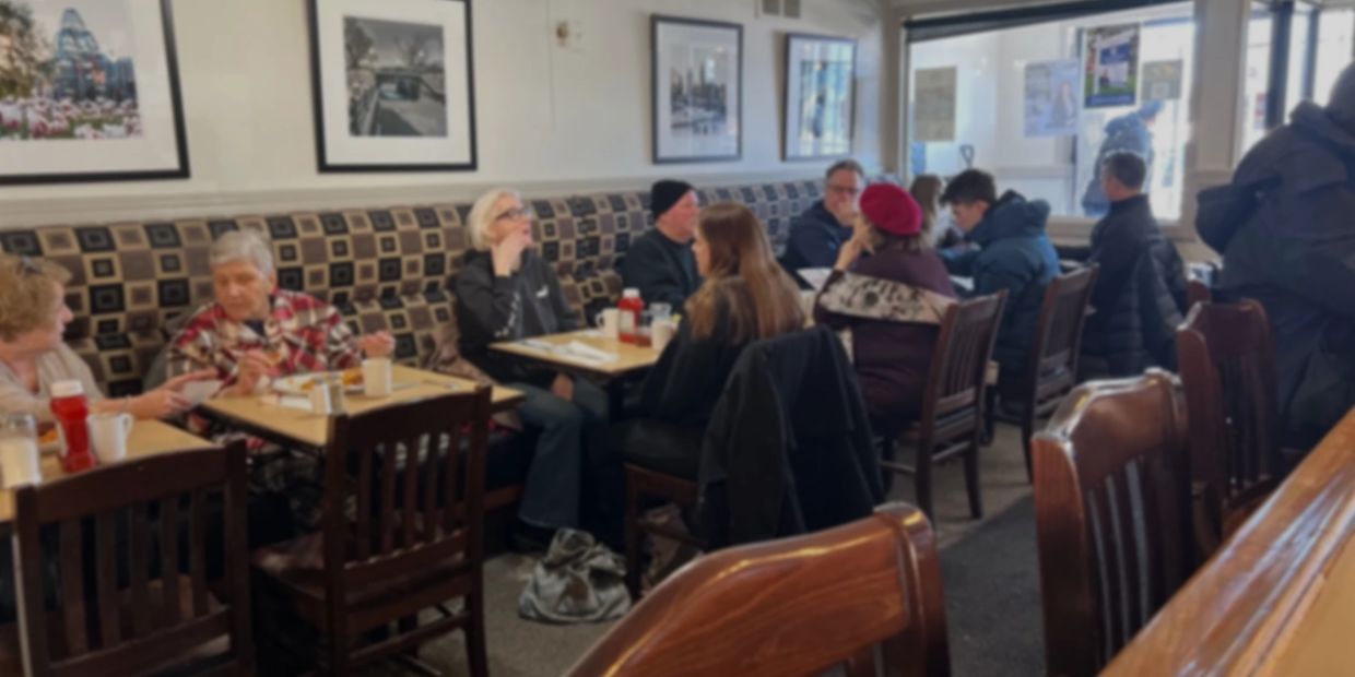 People dining and chatting in a cozy restaurant.