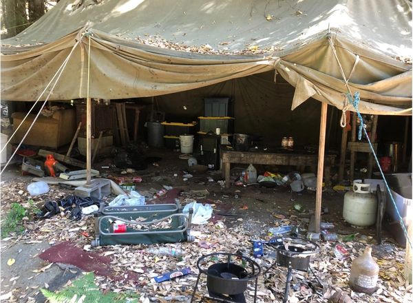 Outdoor tent with trash and chemicals