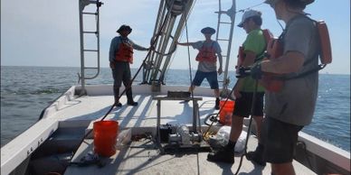 Field work off the Louisiana coast, taking vibracores from the Raccoon Island dredge pit.