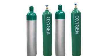 Four green and silver oxygen gas cylinders with valves on top.