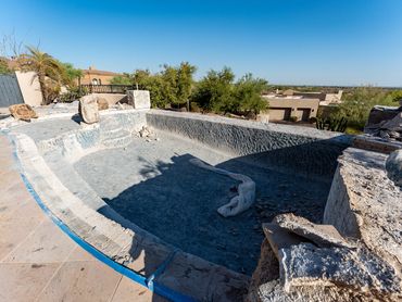 Swimming pool during remodeling after the existing interior surface and finishes have been removed.
