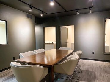 Dark grey office 
Meeting table 
Wood table