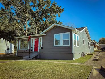Grey house 
Red door 
American flag 
New remodel