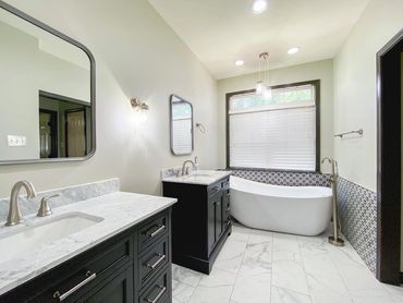 Stand alone tub 
Black vanity 
Tiled floor