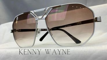 Close-up of stylish Kenny Wayne sunglasses with gradient lenses and silver frame.