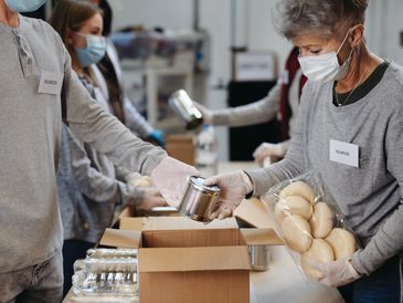 Workers sorting food baskets at food bank