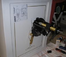 Liberty Safe with key pad removed and mini rig positioned and attached for safe cracking