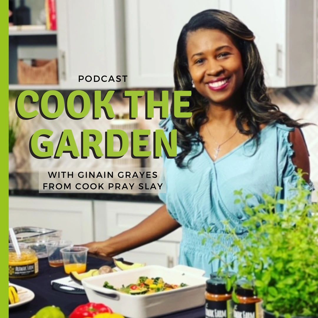 Podcast host, black woman standing at a kitchen island smiling.