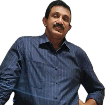 Titus, physiotherapist, with mustache, in blue shirt, professional look.