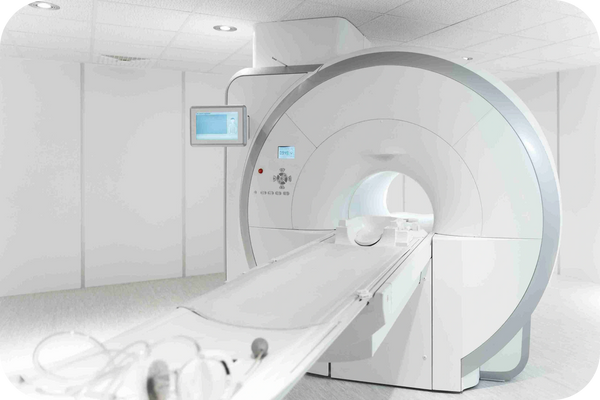 MRI/CT machine in a bright medical room prepared for diagnostic imaging procedures.