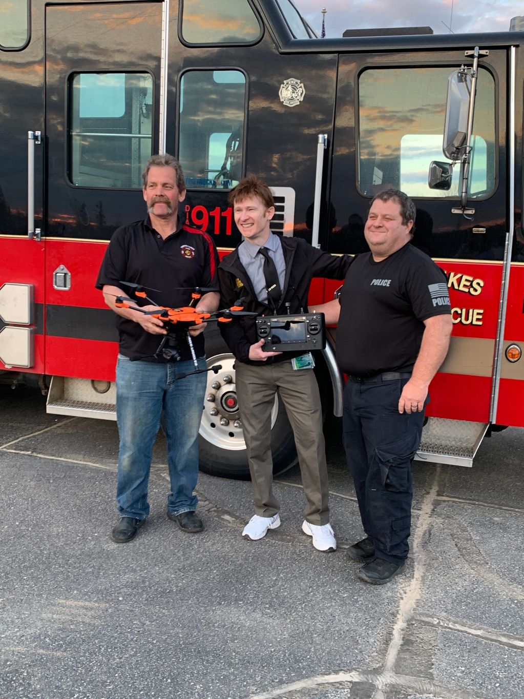 Dave Kirby and Scott Lea receiving the new drone for the Three Lakes Fire Department.