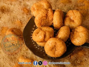 Golden brown fried snacks in hot oil.
