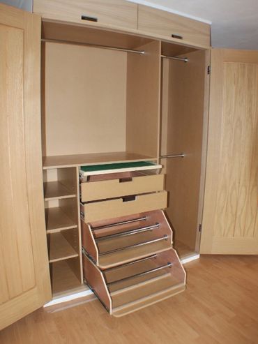 Inside the made-to-measure wardrobe, with hanging space, draws and racks for shoes.
