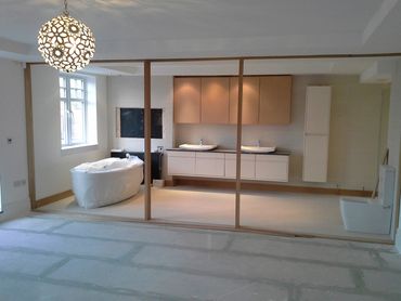 Open space, a new bathroom area with a toilet, 2 sinks and a bath.