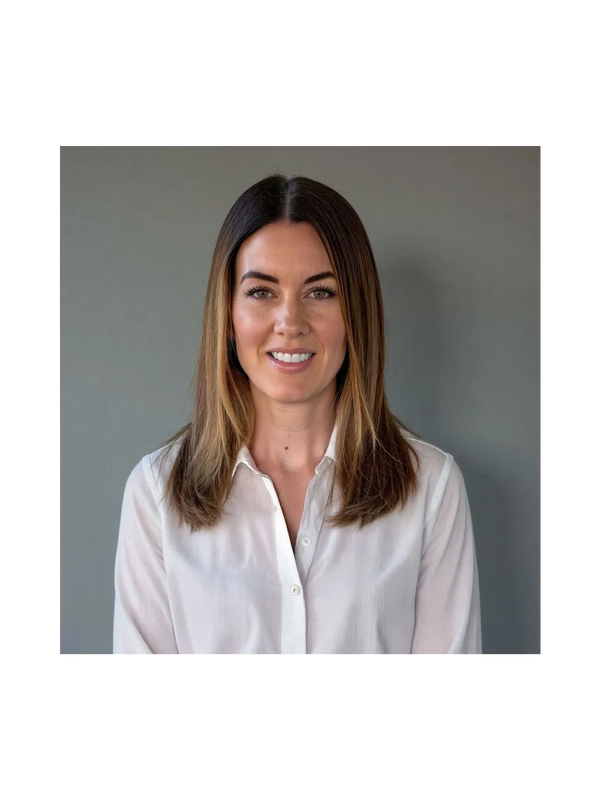Smiling woman with straight brown hair wearing a white blouse.