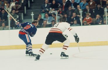Bobby's winding up for a slap shot before Bobby Orr gets in the way in an All Star game.