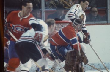Bobby Hull working for positioning against Jaques Laperriere in front of the Montreal Canadiens net.