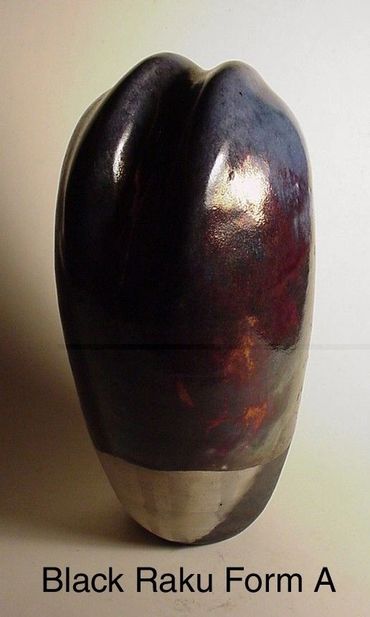 Glossy black raku ceramic form with smooth curves.