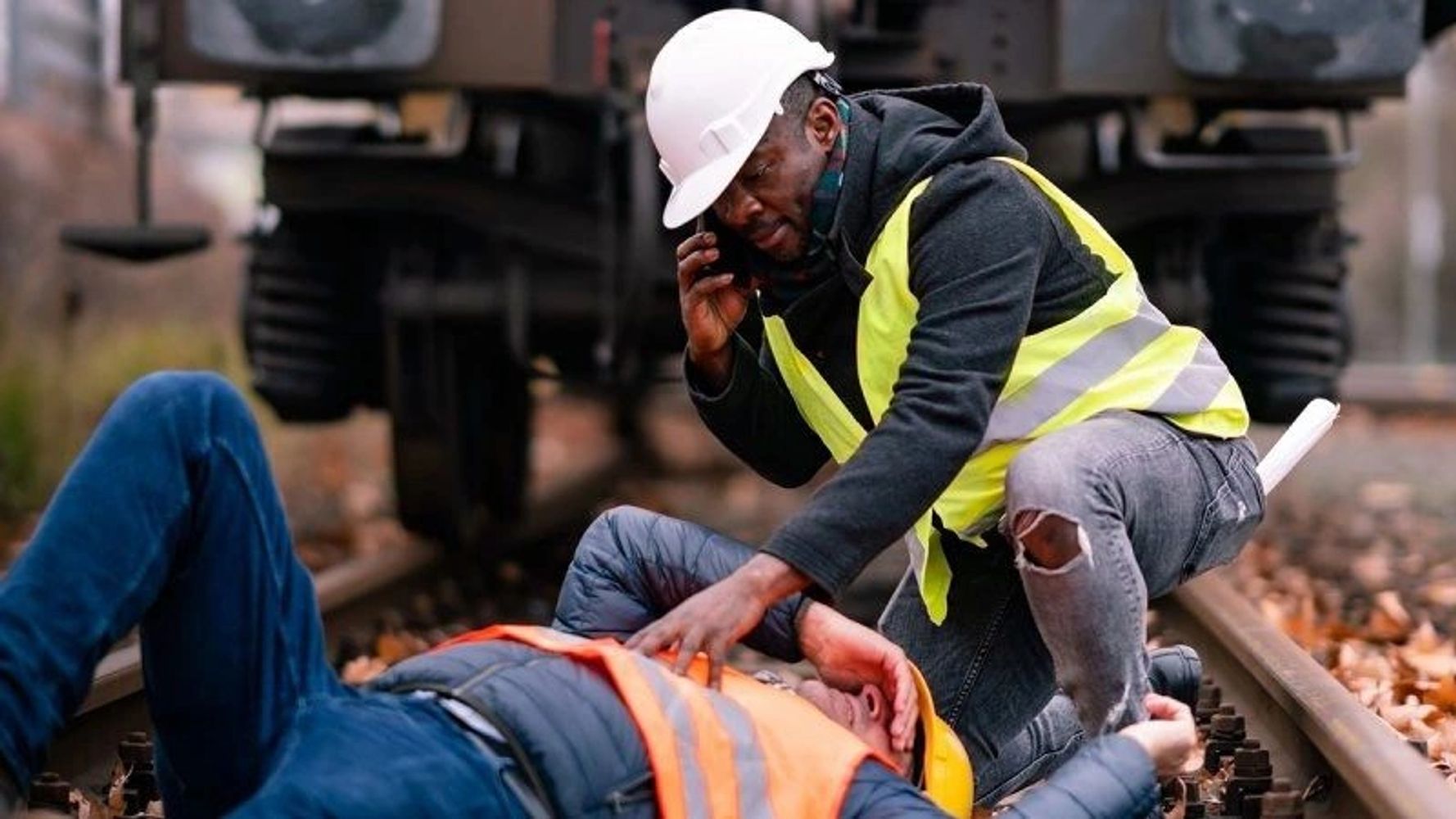 A worker helping a colleague with first aid whilst on a First aid course in Norfolk