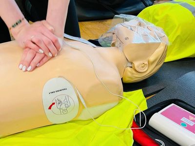 A picture of a first aid trainer doing CPR on a manikin as part of a first aid course in East Anglia