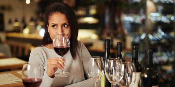 Woman sniffing a glass of red wine