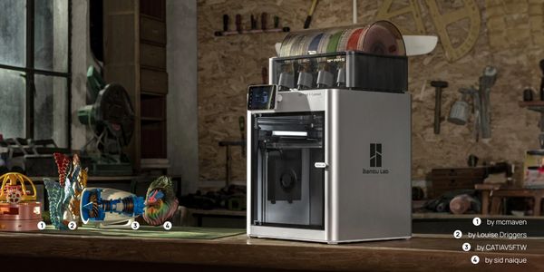 Bambu Lab 3D printer with colorful 3D printed models on a wooden table.