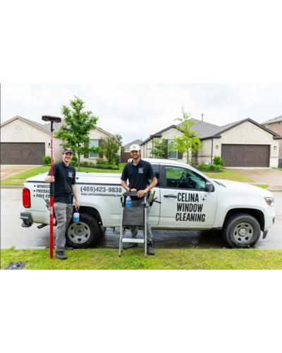 A professional window cleaning team standing beside their branded service truck in a residential neighborhood, showcasing reliable local window cleaning services.