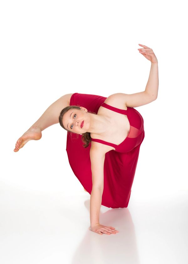 South Sound Dance teen student in red dress performing contemporary floor pose, Tumwater WA.