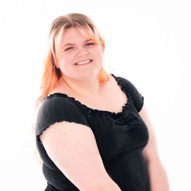 South Sound Dance Kids Musical Theater Director smiling in staff portrait, black top.