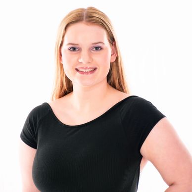 South Sound Dance instructor smiling in staff portrait, black top.