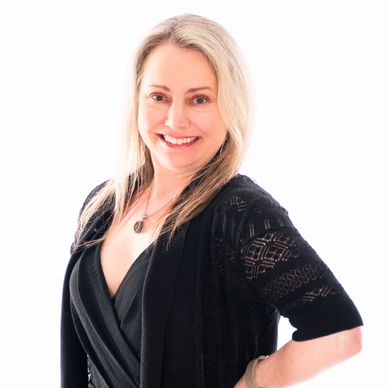 South Sound Dance Amplify Director smiling in professional headshot, black sweater.