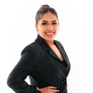 South Sound Dance instructor smiling in staff portrait, black blazer.