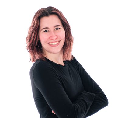 South Sound Dance front desk team member and instructor smiling in black top.