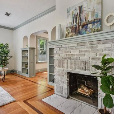professional photo of interior paitning services, whitewash on brick fireplace, grey accent trim