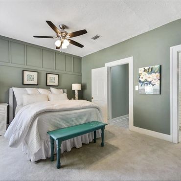 green accent walls, white trim in bedroom, paint application, staged room for rental property