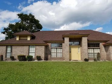 Brick house with yellow accent and trim, yellow door, beautifully paitnted ny J&M painting jax