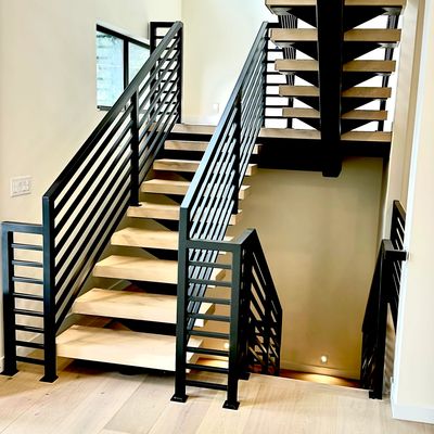 Sleek interior staircase with black railings.