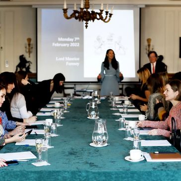 A meeting room with people attending a social event