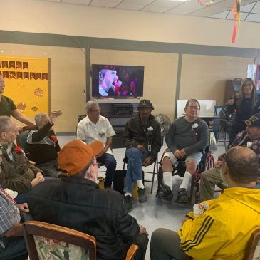 Group of people seated in a circle indoors.