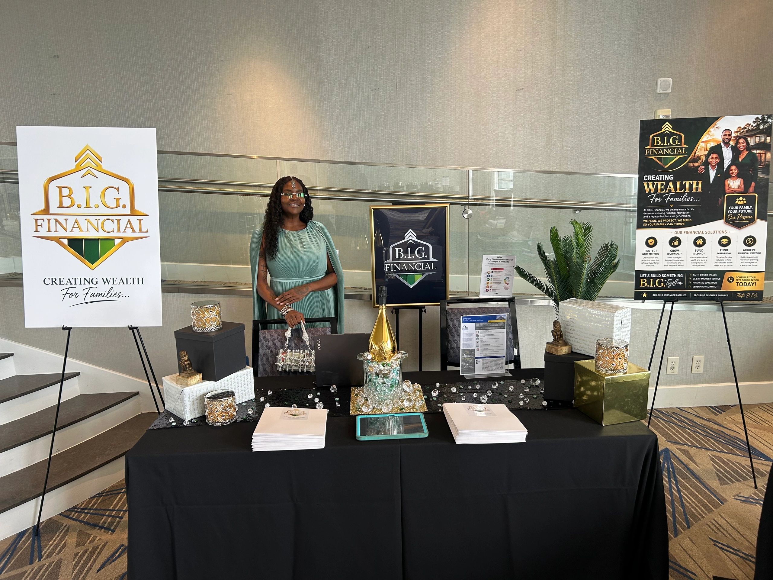 Woman standing at B.I.G. Financial promotional booth.