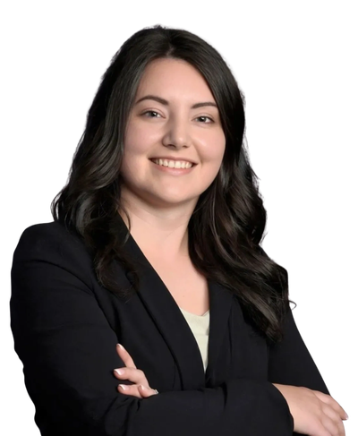 Confident woman with crossed arms smiling.