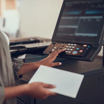 Person using a photocopier machine.